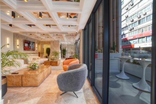 a lobby with two chairs and a table at İbos Hotels Izmir in Izmir