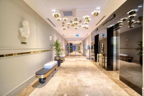 a corridor of a hospital with a waiting room at İbos Hotels Izmir in Izmir