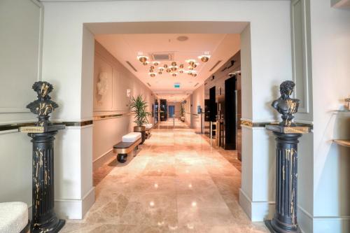 a hallway in a building with a hallway at İbos Hotels Izmir in Izmir