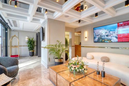 a living room with a couch and a table at İbos Hotels Izmir in Izmir