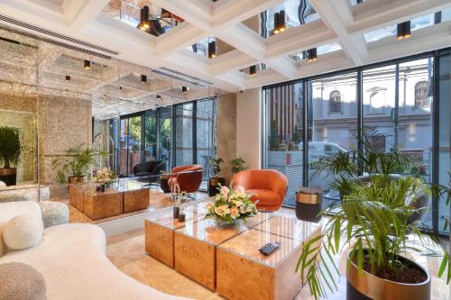 a living room with a table and chairs at İbos Hotels Izmir in Izmir