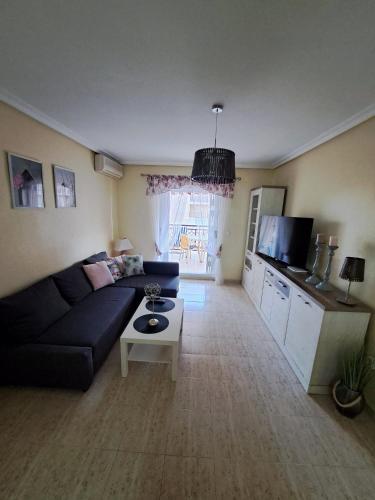 a living room with a couch and a table at Via Mar Apartments in La Mata