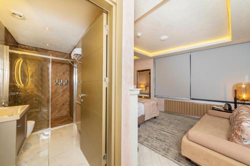 a bathroom with a shower and a bed in a room at Ayramin Deluxe Hotel Taksim in Istanbul