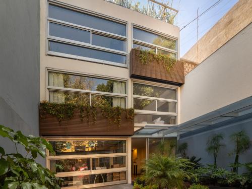 a building with plants on the side of it at Edificio Piso 56 in Mexico City