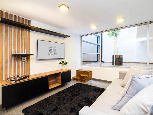 a living room with a tv and a couch at Edificio Piso 56 in Mexico City