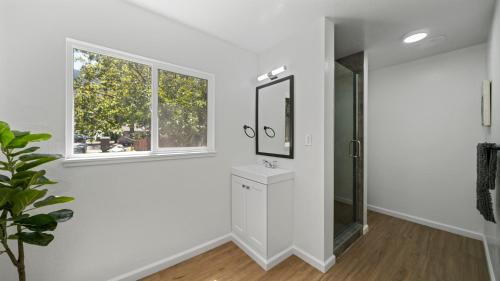 a white bathroom with a sink and a mirror at Adventure Lodge in South Lake Tahoe