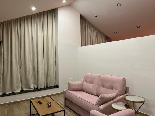 a living room with a pink couch and a window at Casal de pelaio in Barreiros