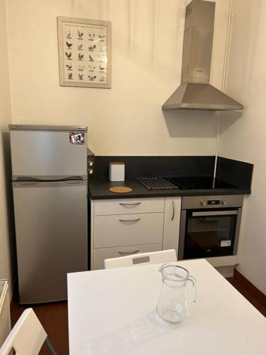 een keuken met een koelkast en een aanrecht bij Studio Les Murettes et parking in Chartres
