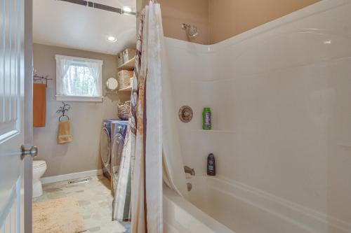 a bathroom with a shower and a tub at Waterfront Lake Webb Cabin Rental with Dock and Views! 