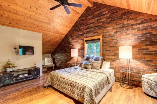 a bedroom with a brick wall and a bed at Gorgeous updated mountain home just minutes from the slopes, private hot tub, pool table! in Breckenridge