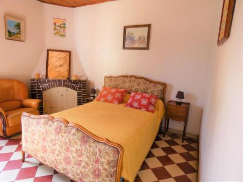 a bedroom with a bed with a couch and a chair at Le point du jour in Lit-et-Mixe