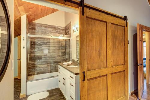 a bathroom with a shower and a wooden door at Gorgeous updated mountain home just minutes from the slopes, private hot tub, pool table! in Breckenridge