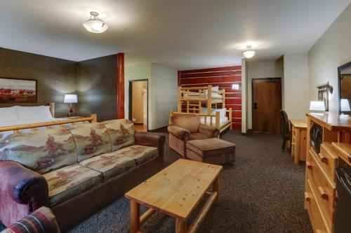 a hotel room with a bed and a couch and a table at Stoney Creek Hotel Sioux City in Sioux City