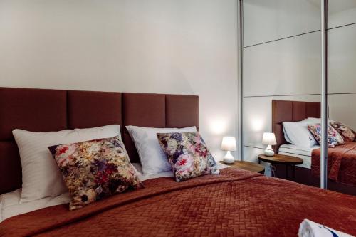 a bedroom with a large bed with two pillows at Apartamenty Belni Hel Edyta i Maciej Wolak in Hel