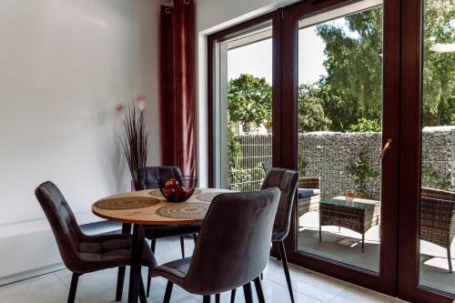 a dining room with a table and chairs at Apartamenty Belni Hel Edyta i Maciej Wolak in Hel