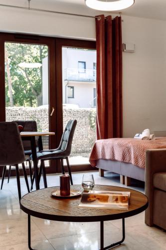 a living room with a bed and a table at Apartamenty Belni Hel Edyta i Maciej Wolak in Hel