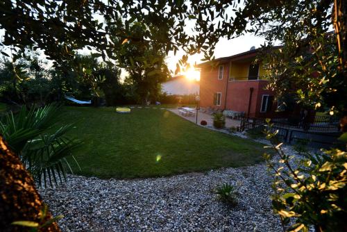 a yard with a house and a frisbee on the grass at Le Palme Sona in Sona