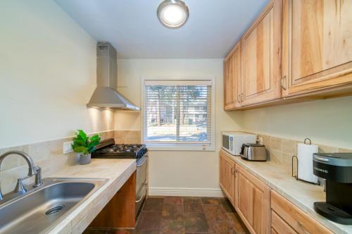 a kitchen with wooden cabinets and a sink and a window at Moose and Maple Lodge in South Lake Tahoe