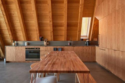 a wooden kitchen with a wooden table and a counter at Alpine House #1 in Steamboat Springs
