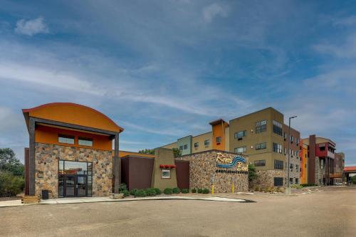 a row of buildings in a parking lot at Stoney Creek Hotel Sioux City in Sioux City