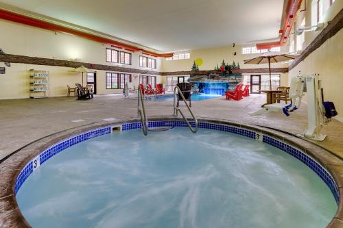a large swimming pool in a building with a gym at Stoney Creek Hotel Sioux City in Sioux City