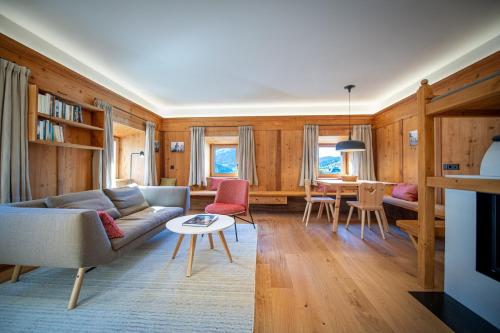 a living room with a couch and a table at Apartments Vedl Luech da Plajes in Ortisei