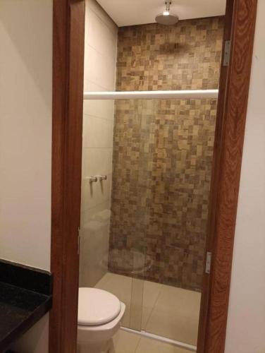 a bathroom with a toilet and a glass shower at THERMAS SÃO PEDRO RESORT in São Pedro