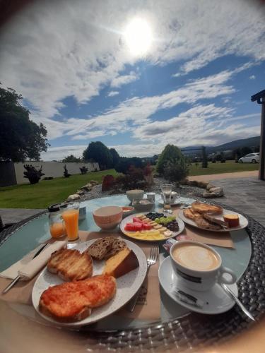 a table topped with plates of food and drinks at Casal de pelaio in Barreiros