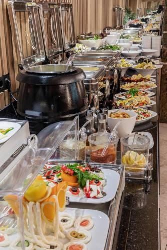 a buffet line with many different plates of food at Ayramin Deluxe Hotel Taksim in Istanbul