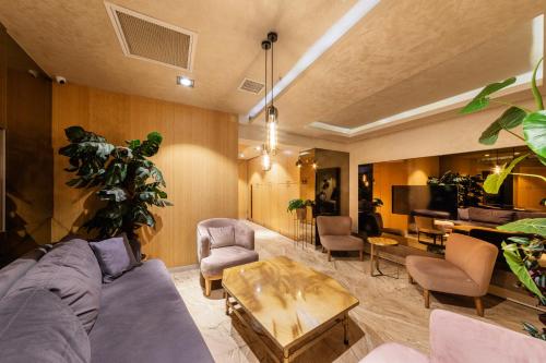 a living room with a couch and a table at Ayramin Deluxe Hotel Taksim in Istanbul