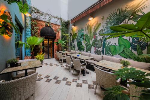 a restaurant with tables and chairs and a mural on the wall at Ayramin Hotel Taksim in Istanbul