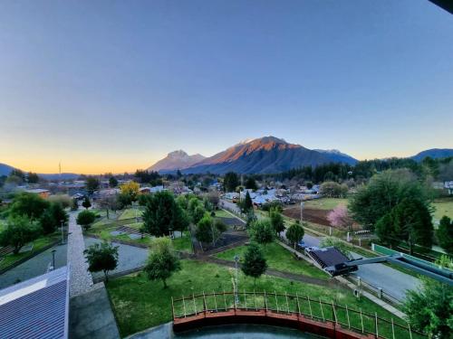 a view of a city with a bridge and a mountain at Cabañas rio Biobio in Callaqui