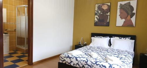 a bedroom with a bed and a shower at Panoias Country House in Vila Real