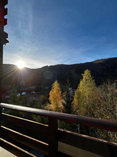 a view of the sun setting over the mountains at Lucas Duplex in Azuga