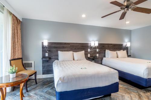 a hotel room with two beds and a table at The Wharf Inn in San Francisco