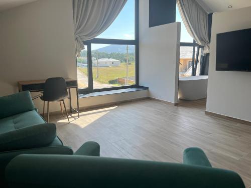 a living room with a couch and a large window at Casal de pelaio in Barreiros