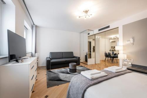a bedroom with a bed and a living room at Milan Royal Suites - Centro in Milan