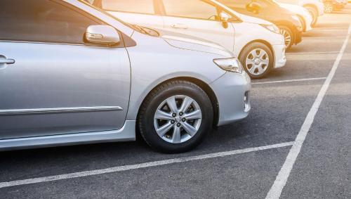 a row of parked cars in a parking lot at The Catrina Hotel in San Mateo