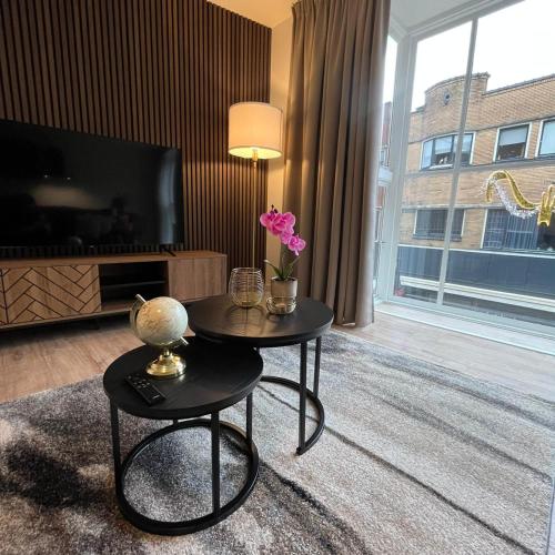a living room with a table with flowers on it at The Residence Apeldoorn in Apeldoorn