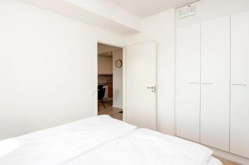 a bedroom with white cabinets and a bed at Viola apartments in Rovaniemi
