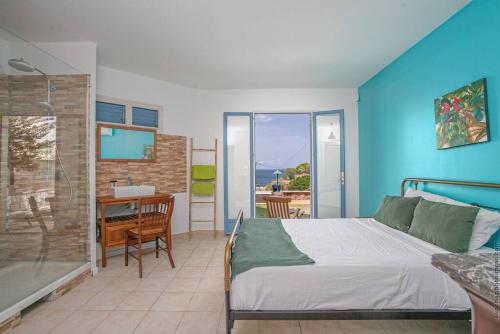 a bedroom with a bed and a table and a desk at Villa Sol Y Sombra in Schœlcher