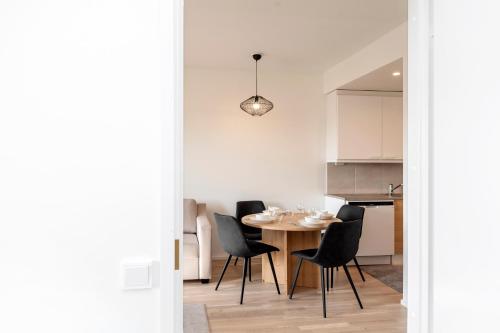 a kitchen and dining room with a table and chairs at Viola apartments in Rovaniemi
