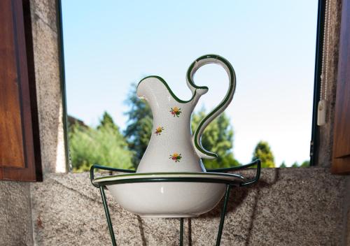 a white vase sitting on top of a wall at Casa de Costoia in Santiago de Compostela