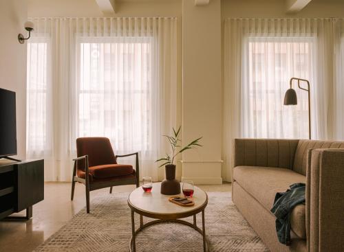 a living room with a couch and a table at Sonder The Craftsman in Los Angeles