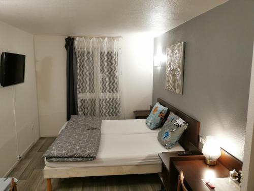 een kleine kamer met een bed en een raam bij Appart Hotel La Defense in Courbevoie
