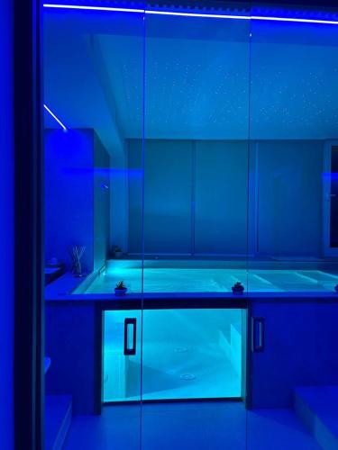 a blue bathroom with a tub in a room at SG Suite & Spa Amalfi Coast in Vietri sul Mare