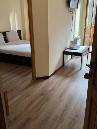 a room with a bed and a table in a room at Verin Tun in Dilijan
