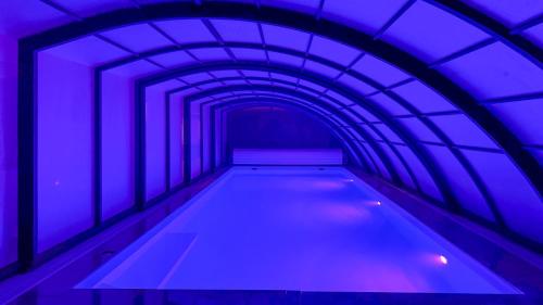 a blue tunnel with a swimming pool at Wczasowa 8 Apartments in Sarbinowo