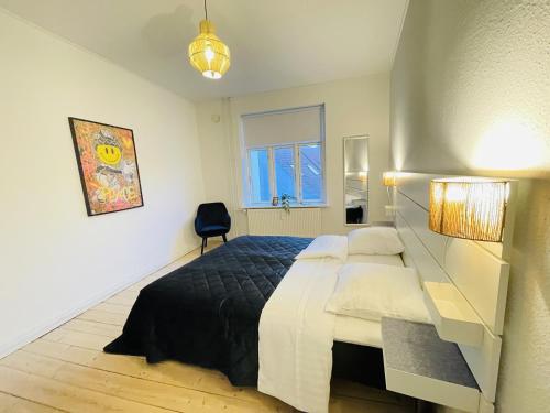 a bedroom with a large bed and a window at aday - Classy 2 bedrooms apartment in the center of Aalborg in Aalborg