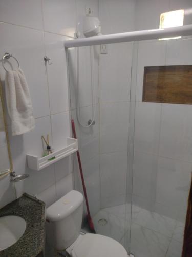 a bathroom with a shower and a toilet and a sink at Casa de praia Rocha Alves em Porto de Galinhas in Porto De Galinhas